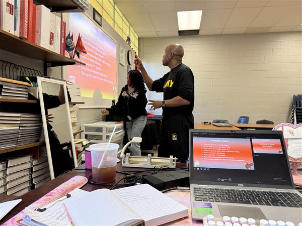 1SG Williams assists Cadet Major Buck in improving PowerPoint presentation skills.